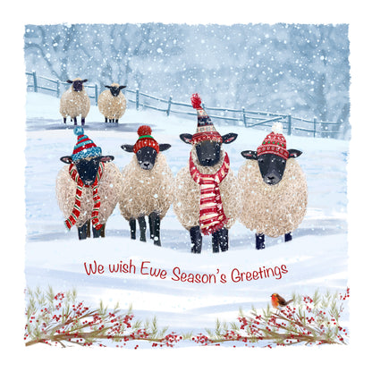 Four sheep in hats and scarves in a snowy field with text saying "We wish Ewe Season's Greetings"